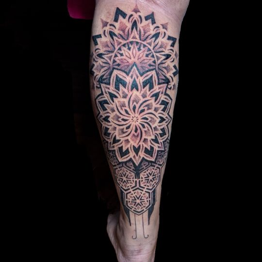 Creative abstract tattoo artwork with bold lines done at 3 Cube Tattoo Studio.