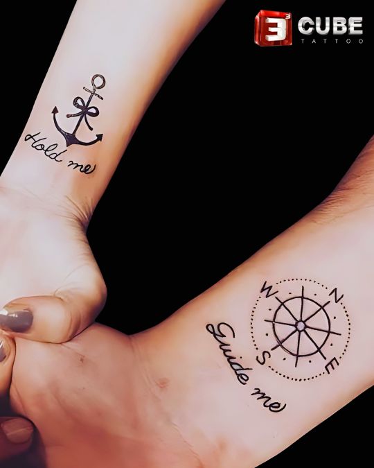 anchor and compass couple tattoo design with “hold me” and “guide me” text by 3cube tattoo studio in kolkata, perfect for couples symbolizing support and direction.