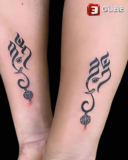 matching minimalist ganesha design couple tattoo in black ink by 3cube tattoo studio kolkata, a cultural and spiritual choice for couples.