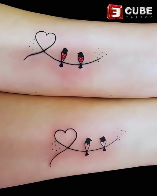 Minimalist matching couple tattoo with birds and heart line at 3cube tattoo studio Kolkata, ideal for couples looking for symbolic and simple tattoo designs.