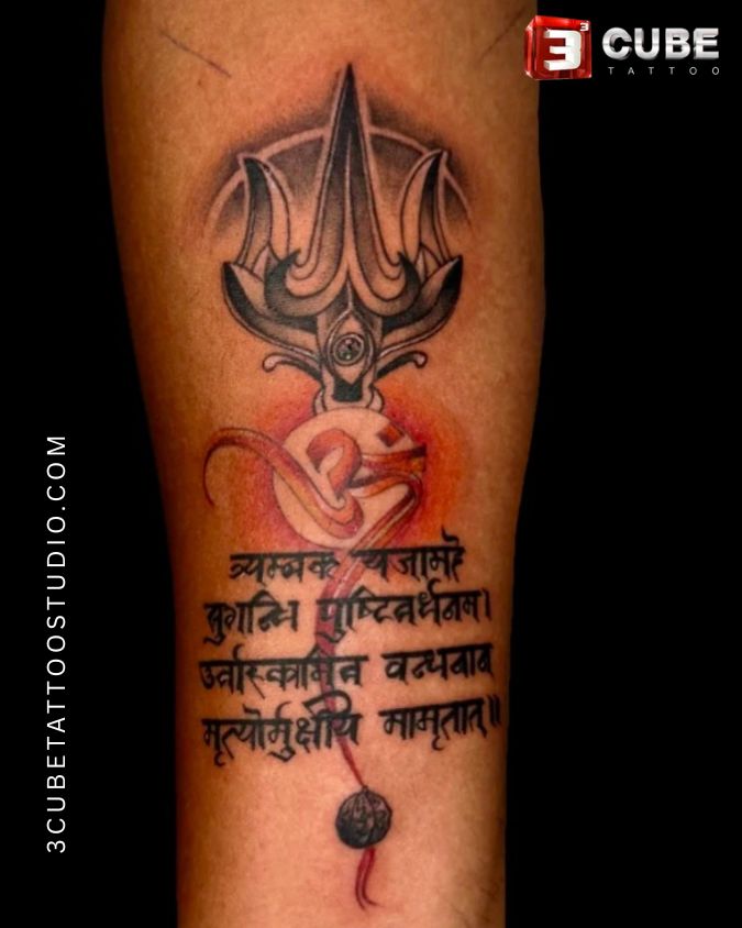 Shiva trishul Tattoo on Hand with mantra and “Om” made by 3 Cube Tattoo