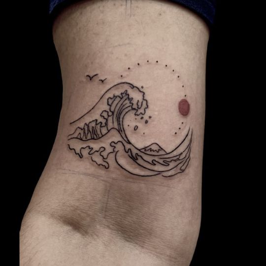 Delicate fine line tattoo of wave design inked with precision at 3 Cube Tattoo.